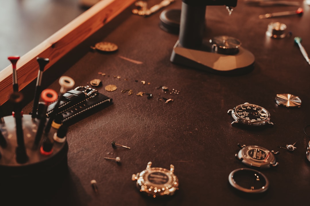 Watch repair tools laid out on a workbench for a battery replacement