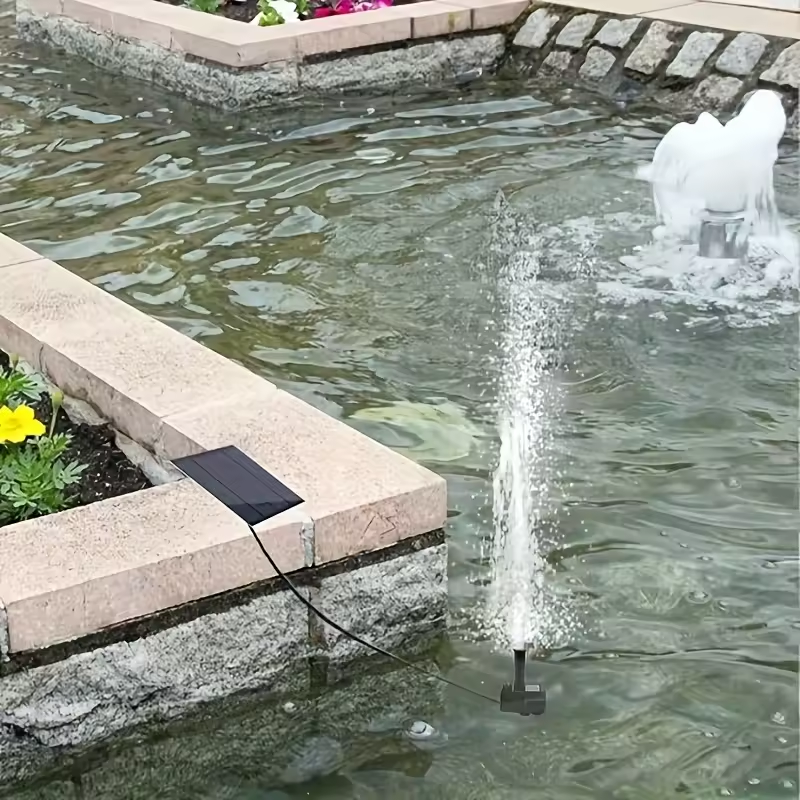 Solar fountain pump floating in a water bowl in sunlight