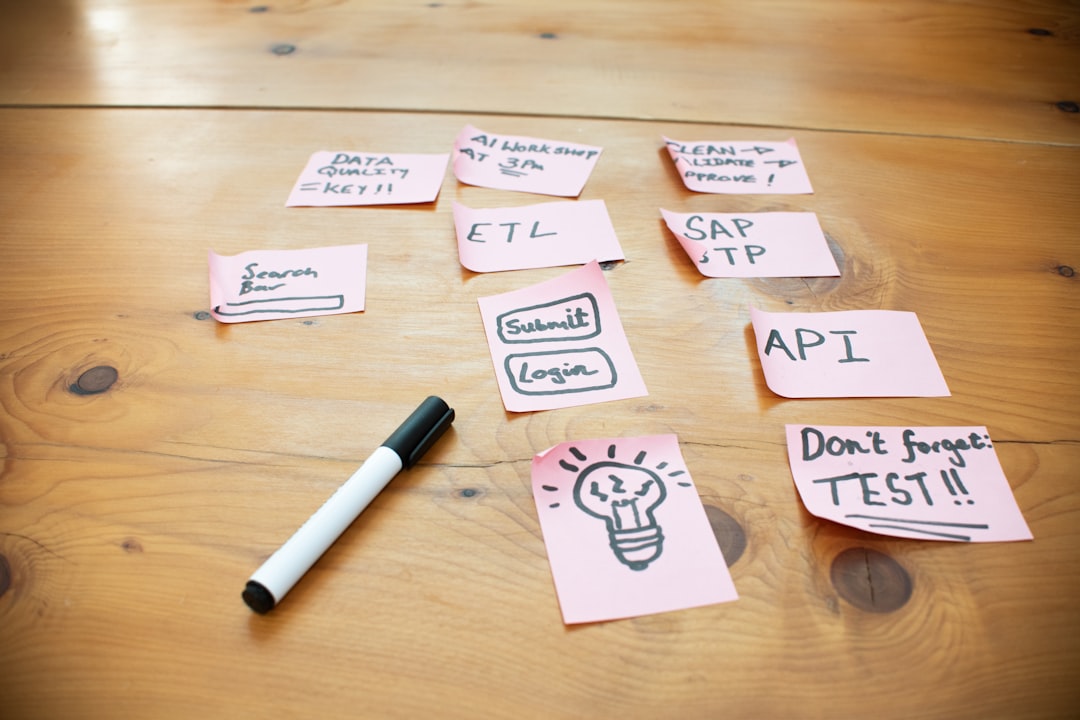 Testing knee massagers side by side — Sticky notes with words and drawings on wooden table.
