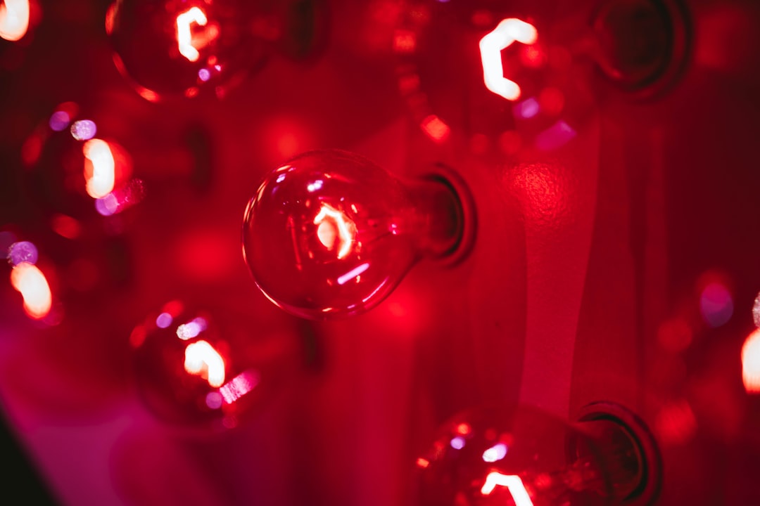 Red light therapy device on the knee — selective photo of red bulb lights