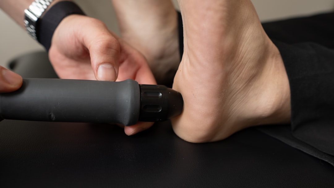 Vibration motor inside a massager — Close-up of a person receiving treatment on their heel.