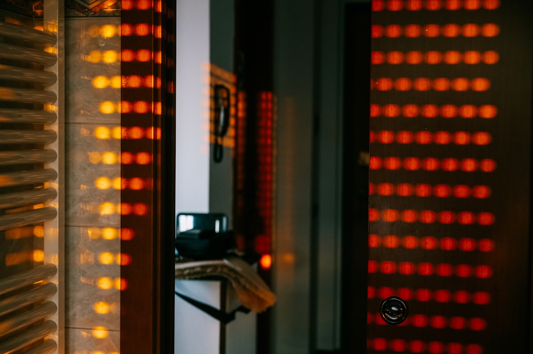 Infrared therapy on a joint — black and red checkered window curtain